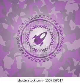 rocket icon on pink camouflaged pattern