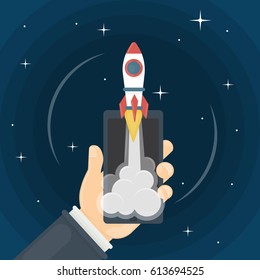 Rocket in smartphone. Hand holds phone with red rocket on the screen. Concept of launching.
