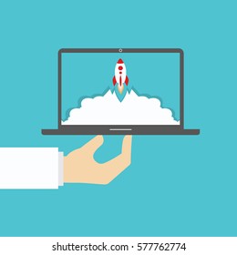 Rocketship on computer for startup media.