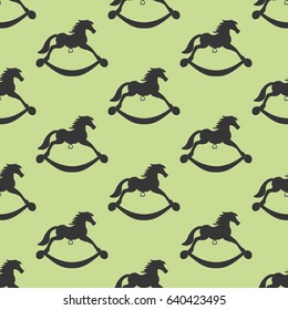 Rocking Horse seamless pattern on the green background. Vector illustration