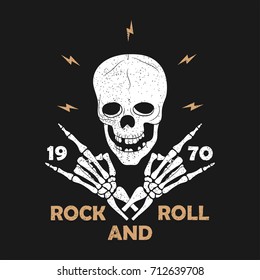 Rock-n-Roll music grunge typography for t-shirt. Clothes design with skeleton hands and skull. Graphics for clothes, print, apparel. Vector illustration.