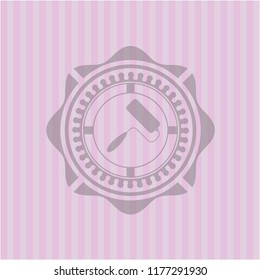 roller brush icon inside badge with pink background
