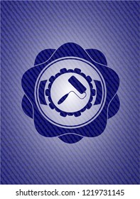 roller brush icon inside badge with denim background