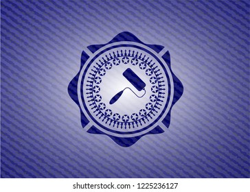 roller brush icon inside badge with denim texture