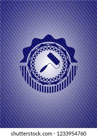 roller brush icon inside badge with denim texture