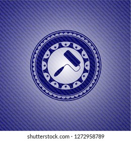roller brush icon inside badge with denim texture