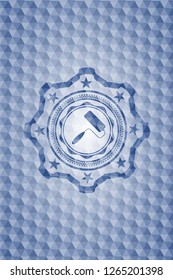 roller brush icon inside blue badge with geometric pattern.