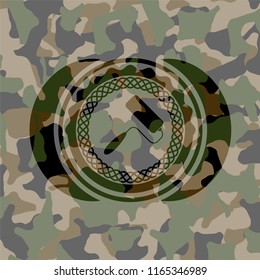 roller brush icon inside camouflaged emblem