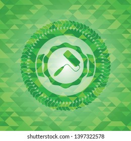 roller brush icon inside green emblem. Mosaic background