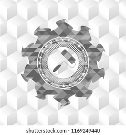 roller brush icon inside grey badge with geometric cube white background