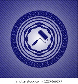 roller brush icon inside jean or denim emblem or badge background