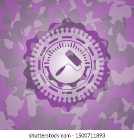 roller brush icon inside pink camouflage emblem