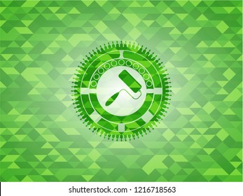 roller brush icon inside realistic green mosaic emblem