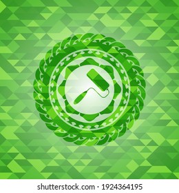 roller brush icon inside realistic green mosaic emblem. 