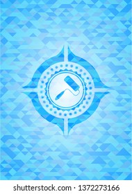 roller brush icon inside sky blue emblem with mosaic ecological style background