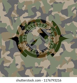 roller brush icon on camouflage pattern