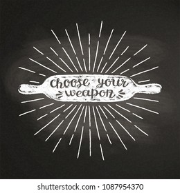 Rolling pin chalk silhoutte with sun rays and lettering - Choose your weapon - on blackboard. Good for cooking logotypes, bades or posters.