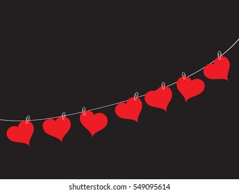 Romantic background from the red hearts hanging on a rope