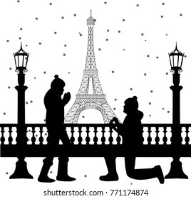 Romantic couple in front of Eiffel tower in Paris a man proposing to a woman while standing on one knee 
as snow falls silhouette, one in the series of similar images