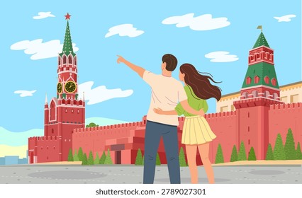Romantic couple, guy and girl, looking at the Kremlin in Moscow, Red Square, Russia.