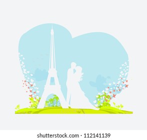 Romantic couple in Paris kissing near the Eiffel Tower