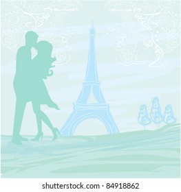 Romantic couple in Paris kissing near the Eiffel Tower.