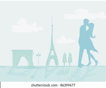 Romantic couple in Paris kissing near the Eiffel Tower.