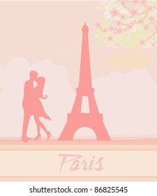 Romantic couple in Paris kissing near the Eiffel Tower. Retro card.