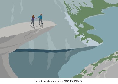 Romantic couple walk on Trolltunga rock (Troll's Tongue rock). One on the most famous place in Norwegian mountain landscape.  