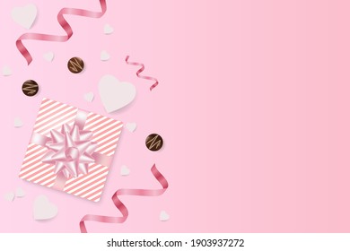 Romantic creative composition.Festive decorative items gift box, chocolates, paper hearts, pink streamer.Holiday banner and poster.