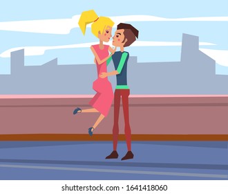 Romantic date on the roof. Loving couple sitting on parapet and hugging. Young people in love kissing. Tender relationships. Boyfriend and girlfriend cuddling