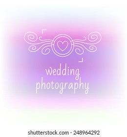 Romantic logo with the image curls camera. Contour plots. Wedding photography, wedding photo studio. Blurred background.