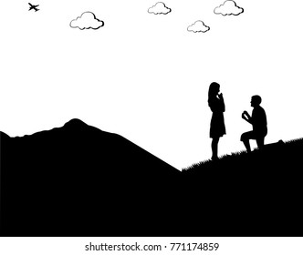 Romantic proposal on top of the mountain of a man proposing to a woman while standing on one knee silhouettes, one in the series of similar images