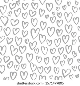 Romantic seamless pattern with cute images of hearts on a white background. The style of children's drawing. Pattern design for valentines day. Stock vector illustration.