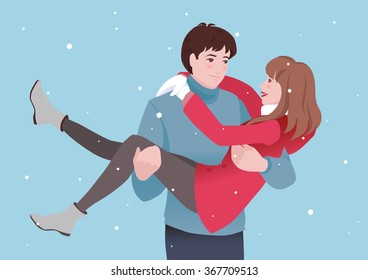 Romantic young couple in love under the snowfall on St Valentines Day