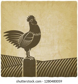 Rooster crows in farm fields vintage background