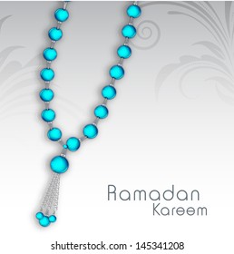 Rosary beads on abstract floral background, concept for muslim community holy month Ramadan Kareem.