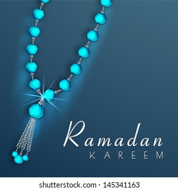 Rosary beads on blue background, concept for muslim community holy month Ramadan Kareem.