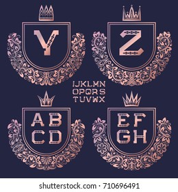 Rose gold coat of arms set in baroque style. Golden pink vintage logos with Y, Z monogram and other letters of the English alphabet.