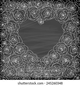 Roses forming heart shaped frame with space for text on chalkboard background.