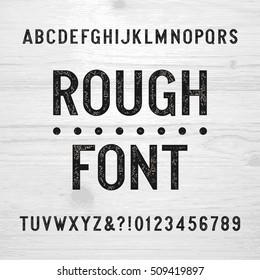 Rough alphabet font. Scratched type letters and numbers on a wooden background. Retro stock vector typography for your design.