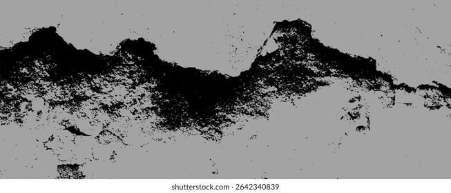 A rough, textured surface shows deep black stains that create a striking contrast against a muted background.