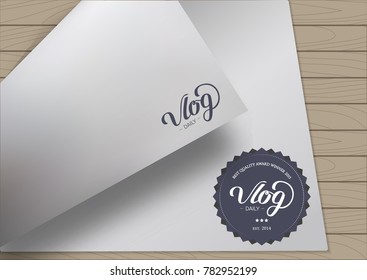 Round Badge Daily Vlog Blogger with Hand Drawn Lettering on Bent A4 Sheet Template Wooden Background. Black Logo Emblem Vector Illustration. Can be used for Logotype, Branding.