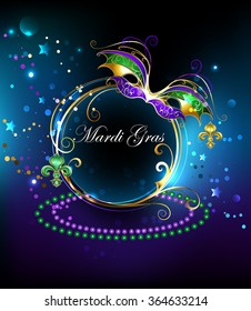 Round banner decorated with gold Mardi Gras mask on black glowing background.