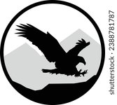 Round black and white stamp style wild eagle soaring silhouette with mountains in the background graphic. Vector eps design.