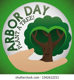 Round button with a hand holding a cute, smiling tree with heart shaped foliage, promoting tree plantation to celebrate Arbor Day.