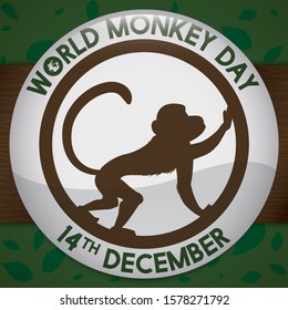 Round button with primate silhouette over wooden branch and background with leaves pattern ready for World Monkey Day celebration this 14th December.