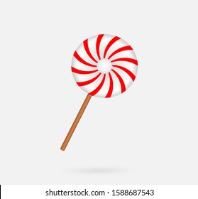 Round candy on stick a red and white on a gray background.