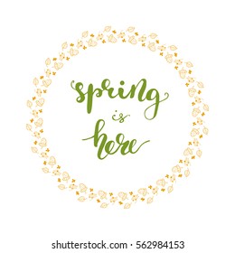 Round card design element with hand drawn lettering "Spring is here" and floral wreath. Vector illustration
