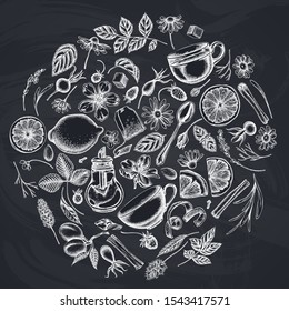 Round design with chalk cinnamon, lemons, oranges, tea bag, sugar cubes, heather, chamomile, dog rose, peppermint, almond, strawberry, teaspoon, teapots, cups, sugar bowl